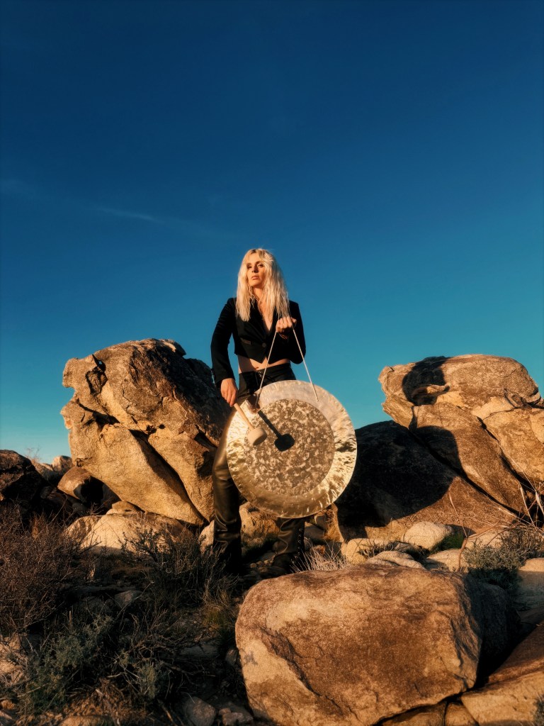 Elise with gong on rocks